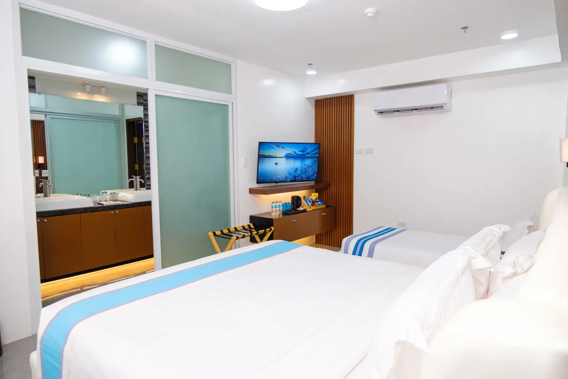 Family Room: a large bed, a single bed and a wall-mounted TV